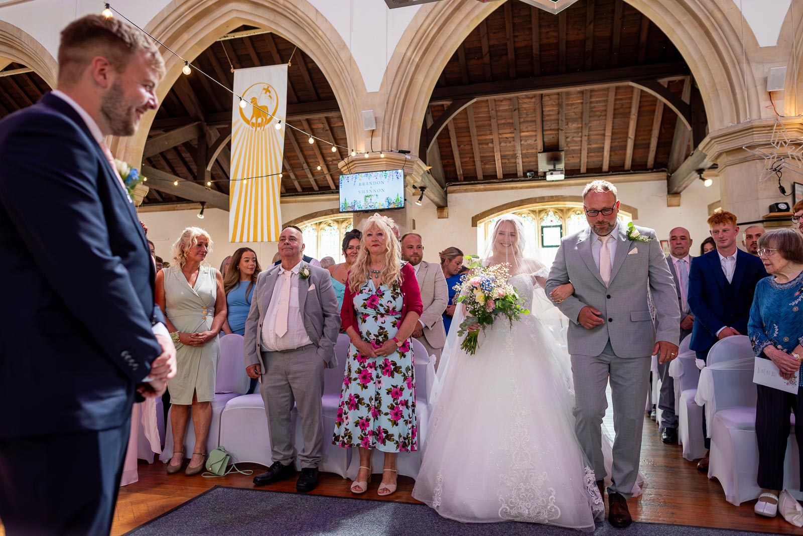 Shannon arrives arm in arm with her father at the bottom of the aisle in St. Michael and All Angels Church in Eastbourne before her wedding to Brandon.