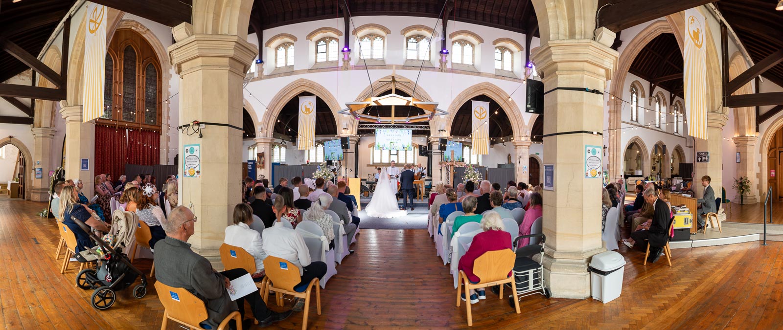 Shannon and Brandon at the bottom ofd the aisle in St. Michael and All Angels Church in Eastbourne during their wedding.