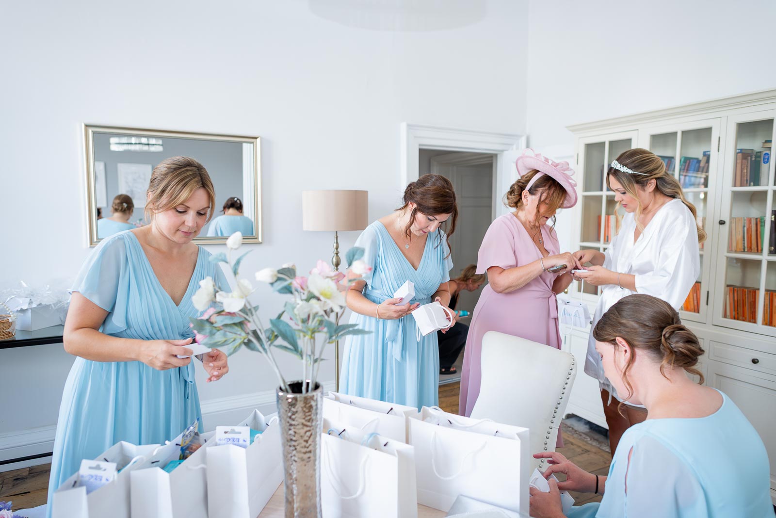 Sarah and her bridesmaids look at wedding favours in The Pelham Suite at Pelham House Hotel, Lewes. 