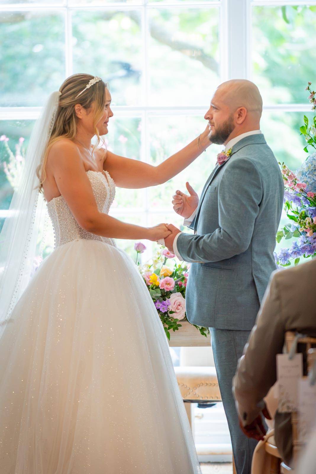 Sarah greets Lewis before their wedding at the bottom of the aisle in the Goring Room at Pelham House Hotel, Lewes. 