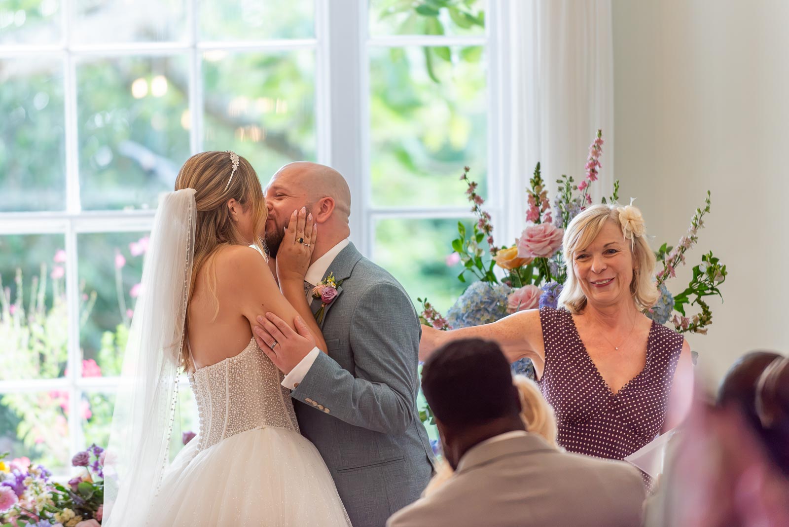 Sarah kisses Lewis after their wedding at the bottom of the aisle in the Goring Room at Pelham House Hotel, Lewes. 