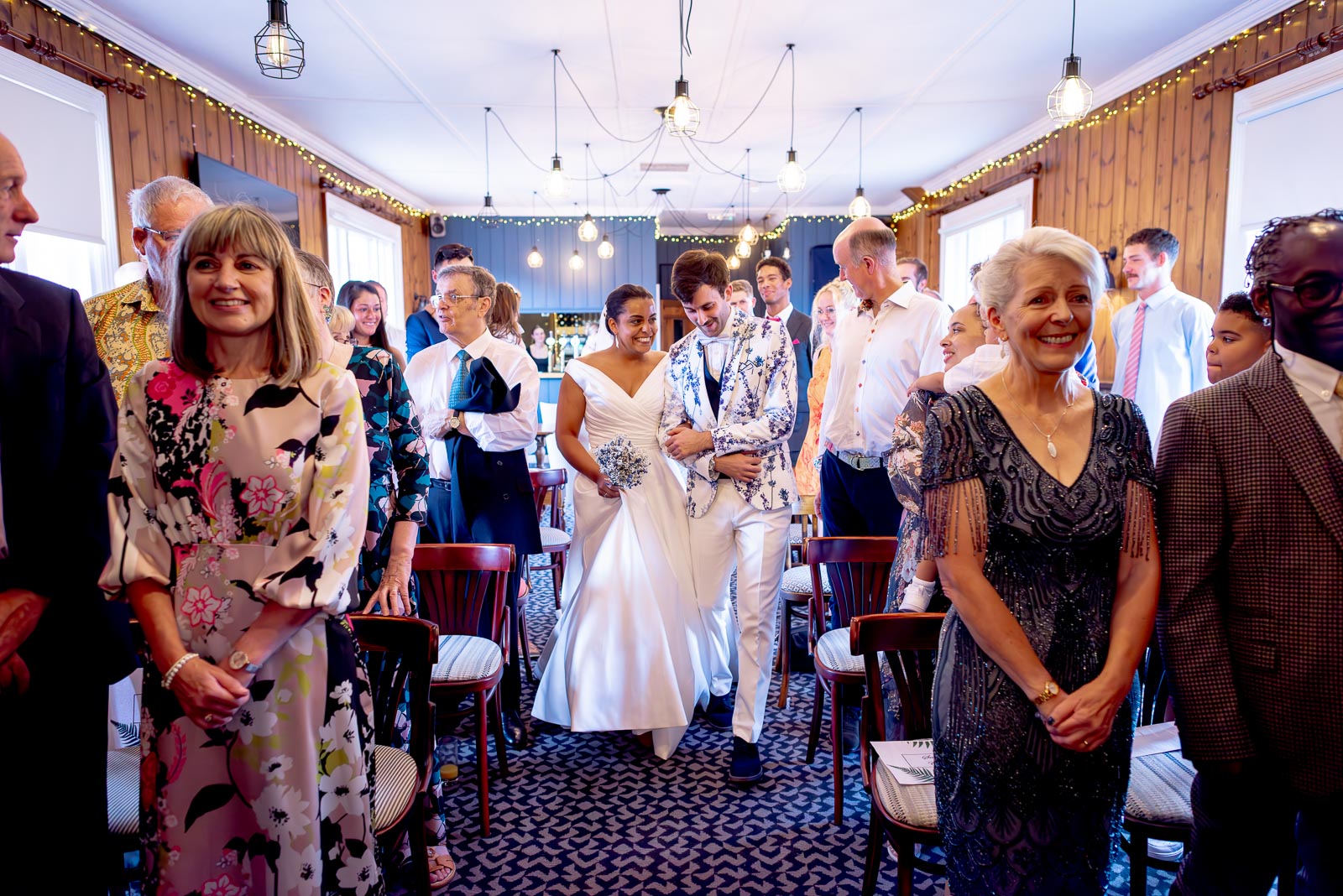 Ed and Olivia walk down the aisle in the function room at The Royal Oak in Lewes