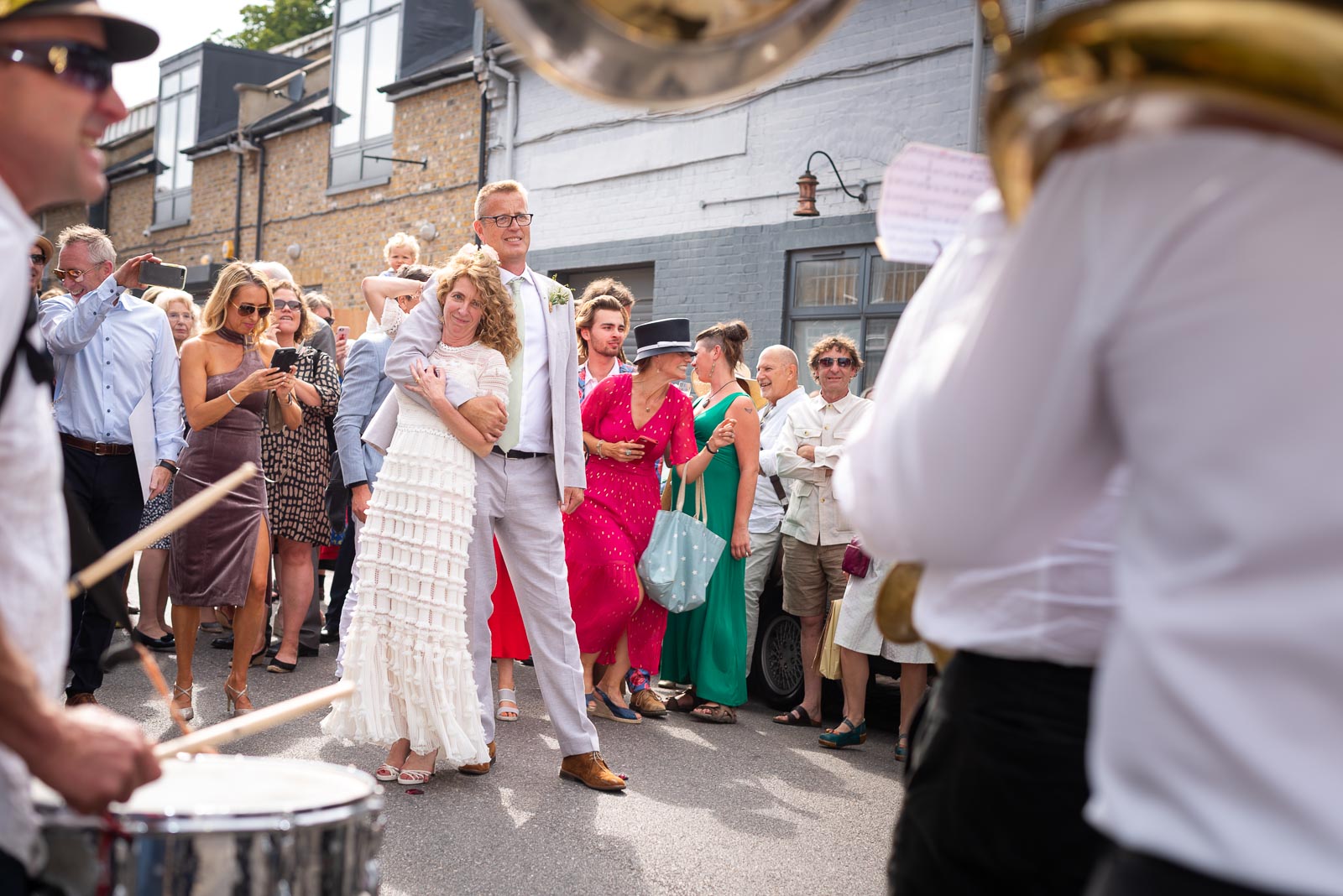 Kitty and Will enjoy listening to the band after their wedding in the Band Stand at Queens Park in London.