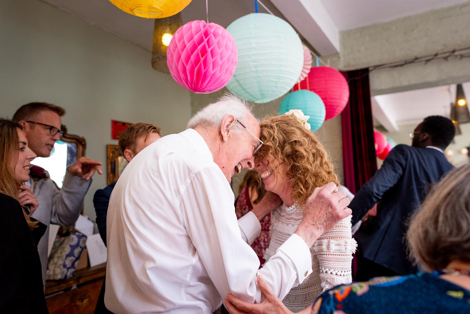 Kitty and her father enjoy a moment during her wedding reception.