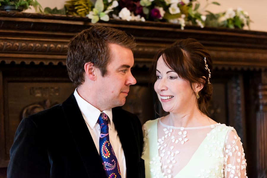 Fiona and Richard smile at eachother after getting married at Lewes Register Office.