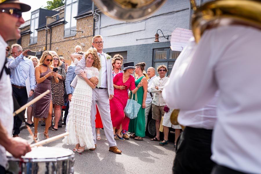 Kitty and Will enjoy listening to an outdoor band after their wedding in the Bandstand at Queens Park in London.