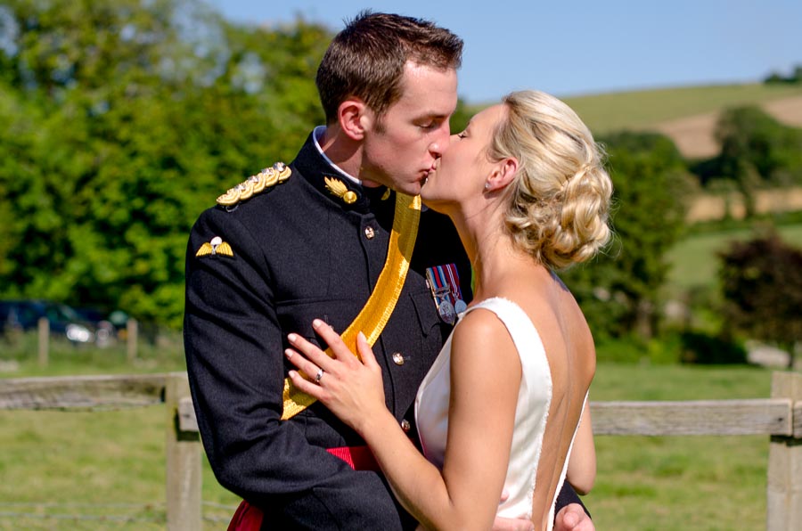 Rachael and Dan embrace after getting married at their wedding reception Burpham Village Hall.